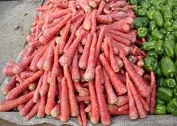 carrots and green bell peppers in a market